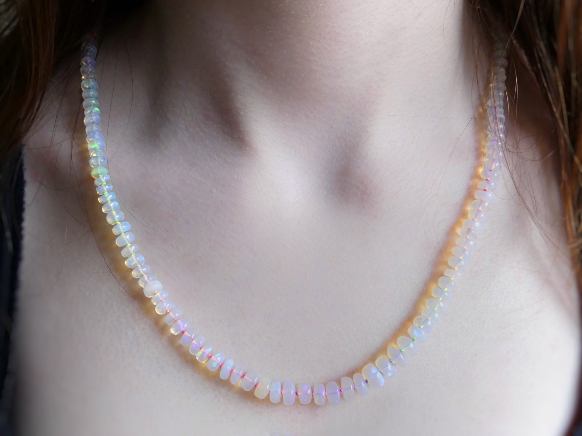 Ethiopian opal necklace with 5–7mm rondelles hand-knotted on neon rainbow silk, finished with a gold-filled clasp

