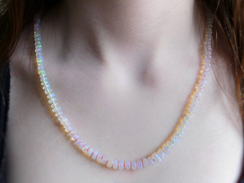 Ethiopian opal necklace with 5–7mm rondelles hand-knotted on neon rainbow silk, finished with a gold-filled clasp

