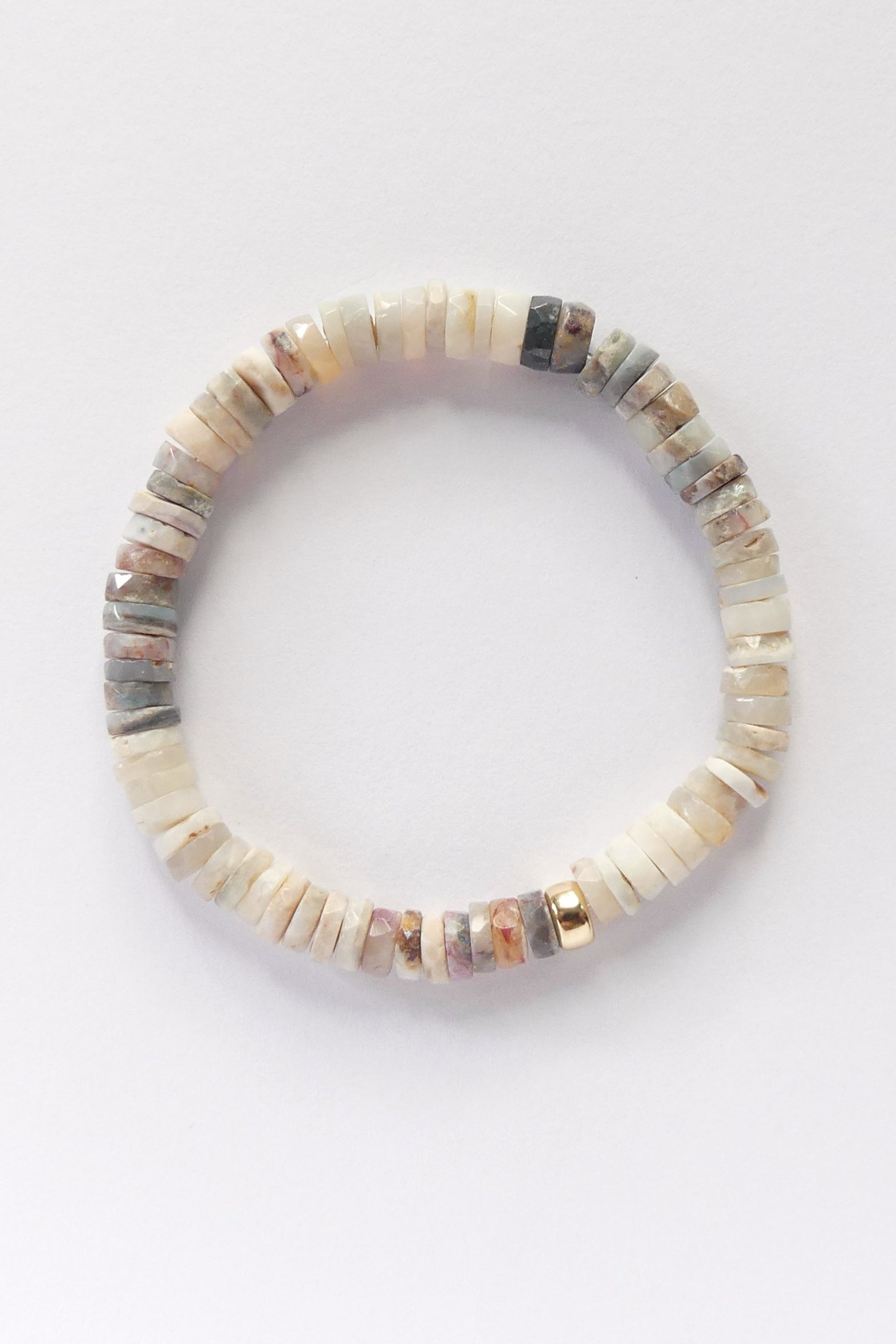 Stretch bracelet with natural Australian opal 6mm heishi beads and a gold-filled accent, shown coiled flat on a white background

