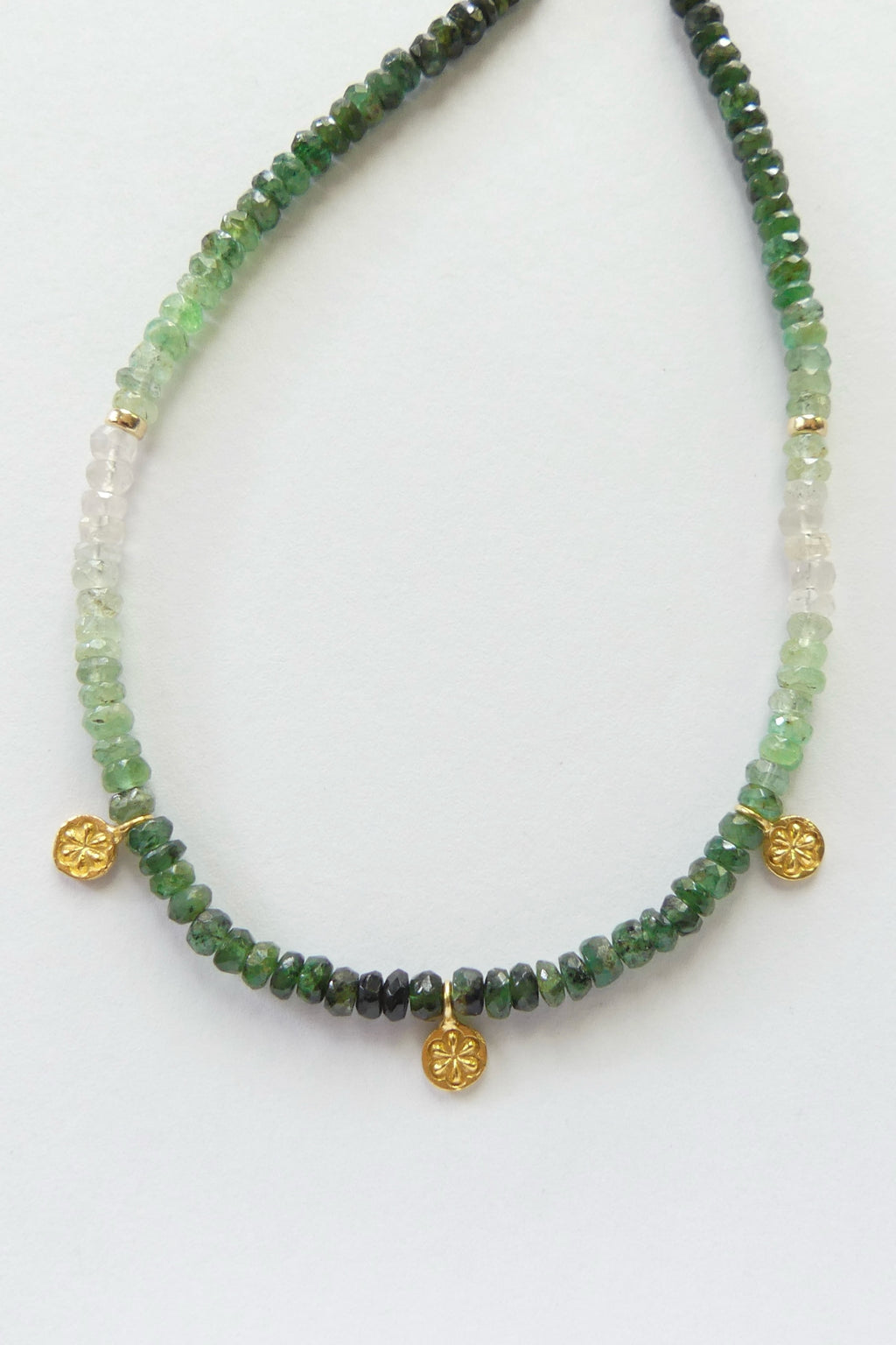 Dainty ombré emerald necklace with faceted green gemstone beads, gold vermeil daisy charms, and adjustable gold-filled clasp, 16 to 18 inches long
