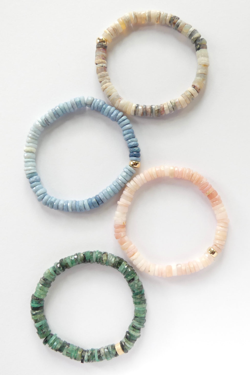 Stretch bracelet with natural Australian opal 6mm heishi beads and a gold-filled accent, shown coiled flat on a white background

